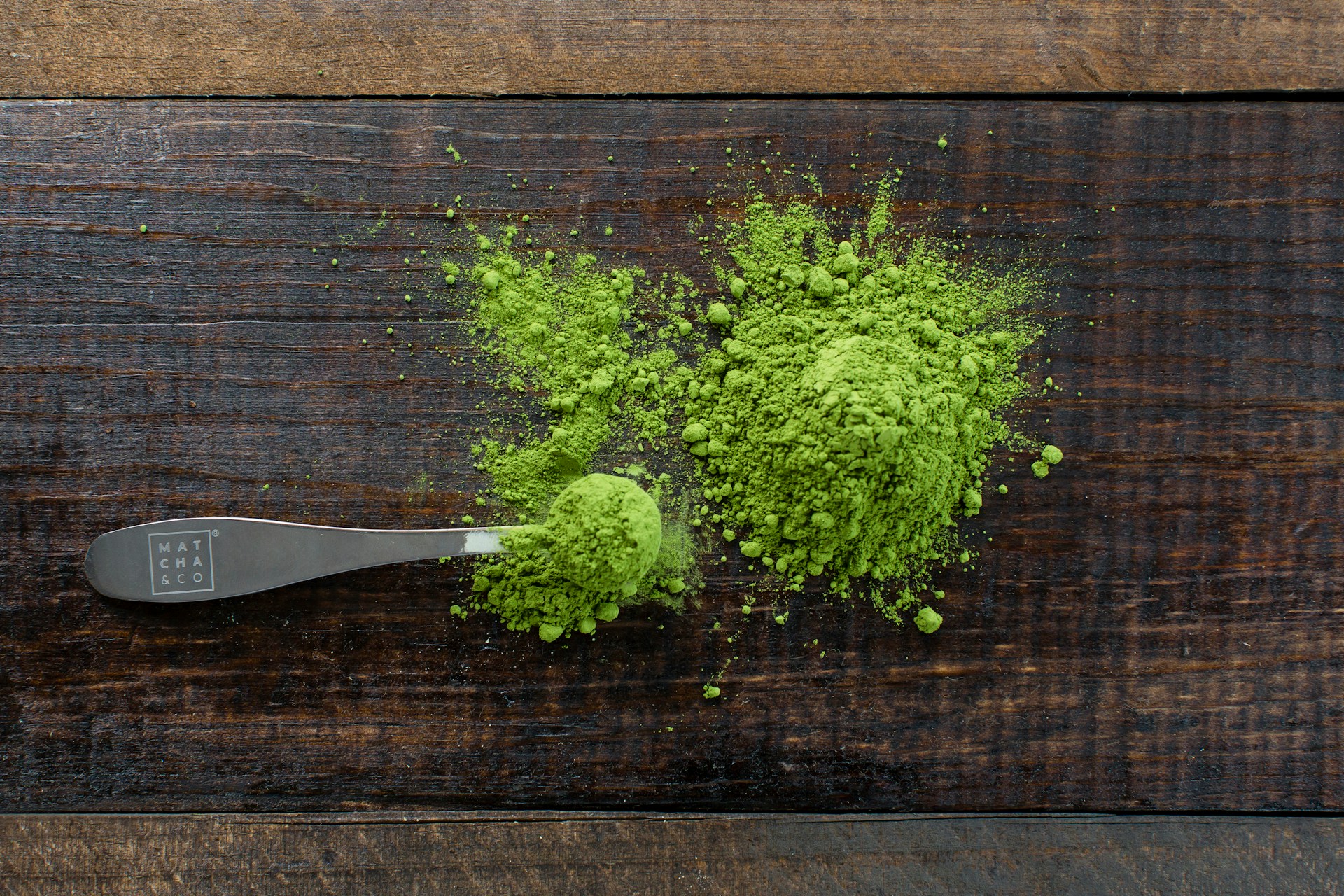 green powder and scoop on a board