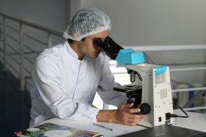 a scientist looking through a microscope