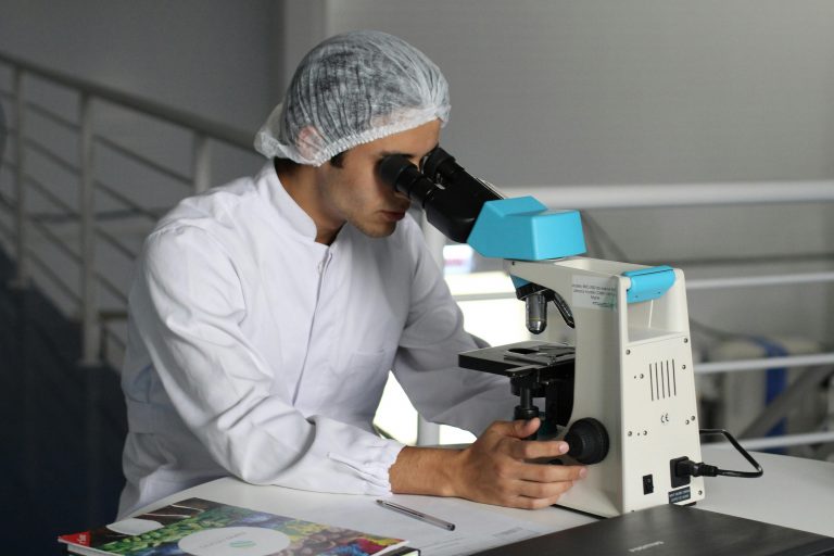 a scientist looking through a microscope