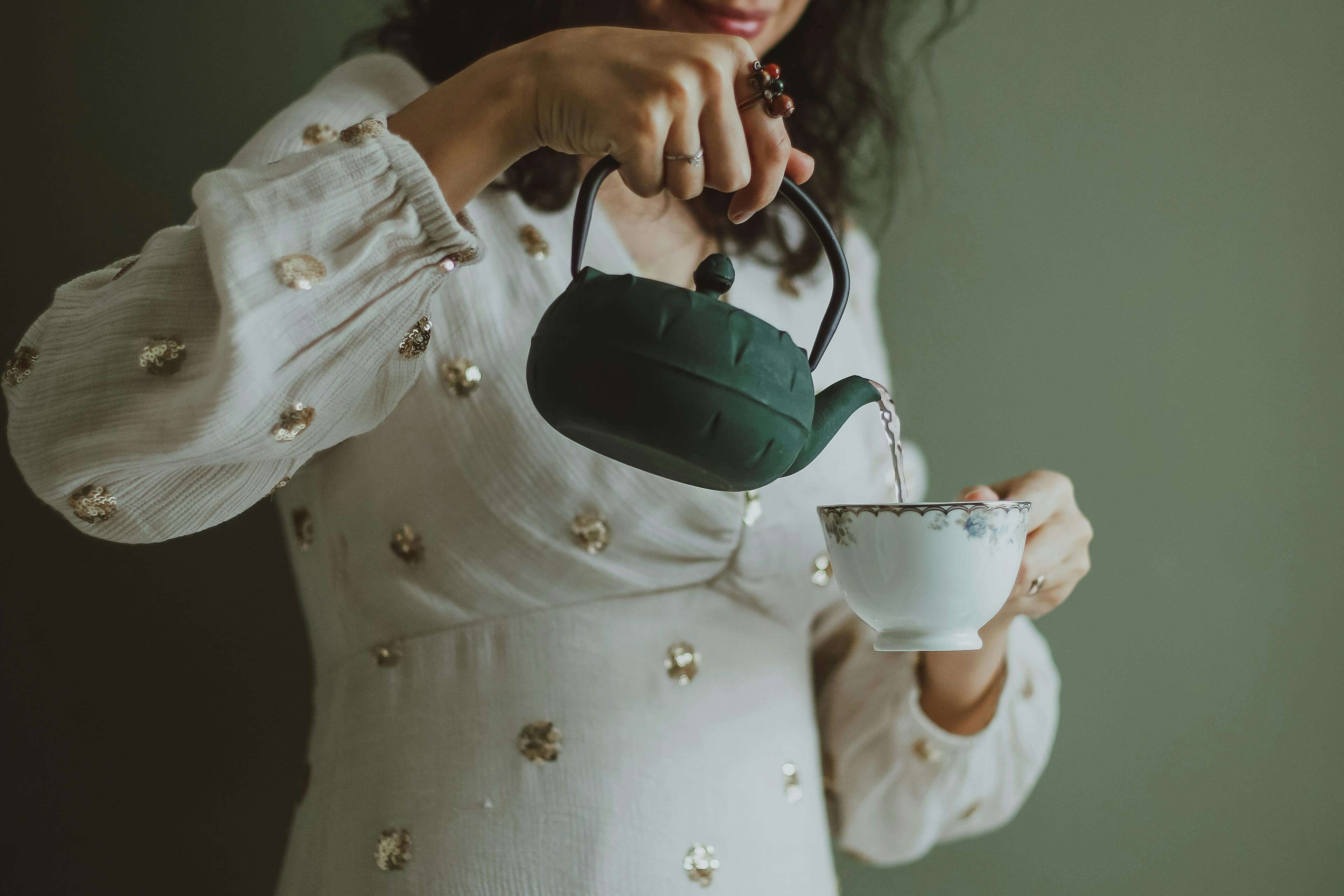 woman pouring tea in a cup