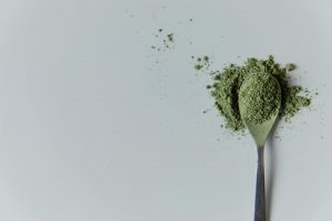 Kratom powder in a spoon